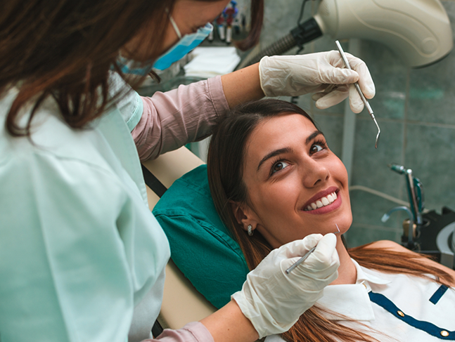 Woman smiling at her dental hygienist