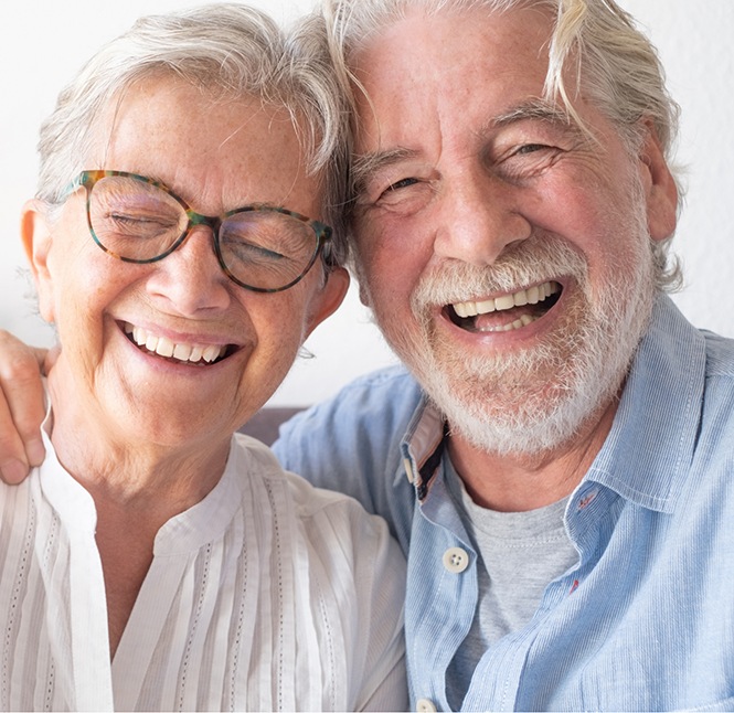 Senior couple smiling with All-on-4 dental implants in San Antonio