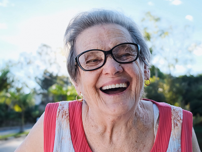 Senior woman laughing outdoors