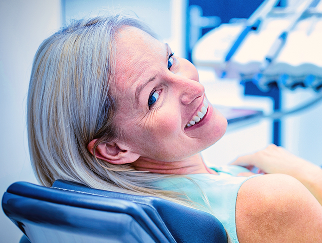 Smiling older woman in the dental chair
