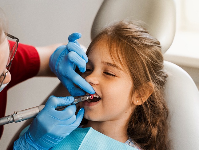 Little girl having teeth professionally polished