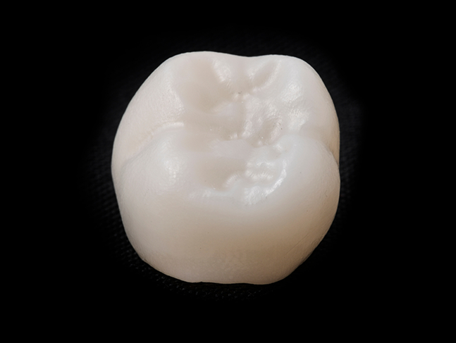 Dental crown against a black background