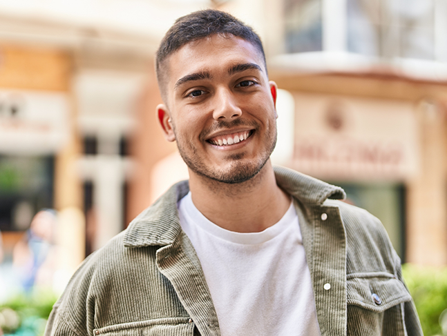 Young man smiling in a light green jacket