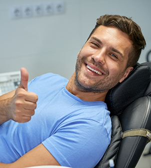 Young man giving a thumbs up in the dental chair