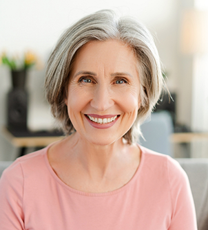 Smiling senior woman in a pink blouse