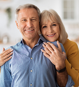 Senior couple embracing at home