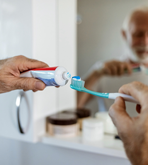 Senior man brushing his teeth