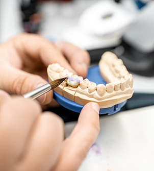 Dental ceramist crafting a denture