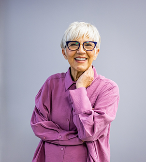 Smiling senior woman in a purple blouse