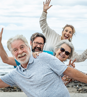 Four seniors taking a selfie on the beach