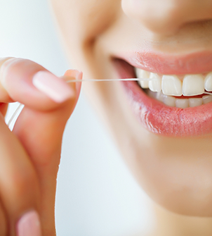 Person flossing their teeth