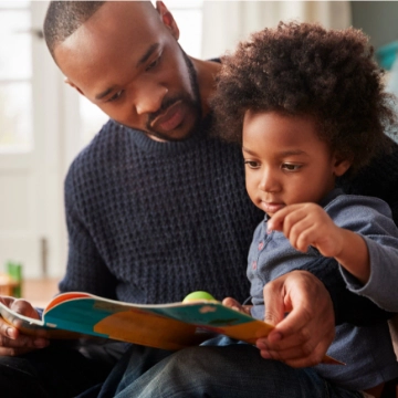 Father reading a book to his toddler