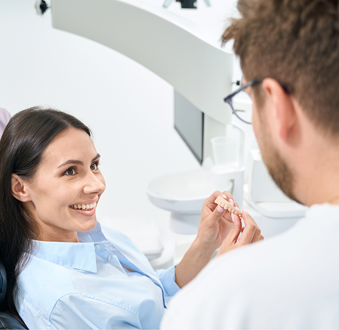 Woman smiling while talking to her dentist in San Antonio