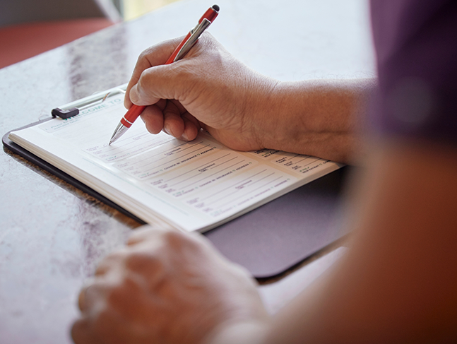 Person filling out a paper form