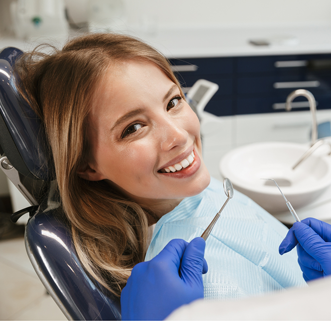 Woman smiling during her checkup at a dental office in San Antonio