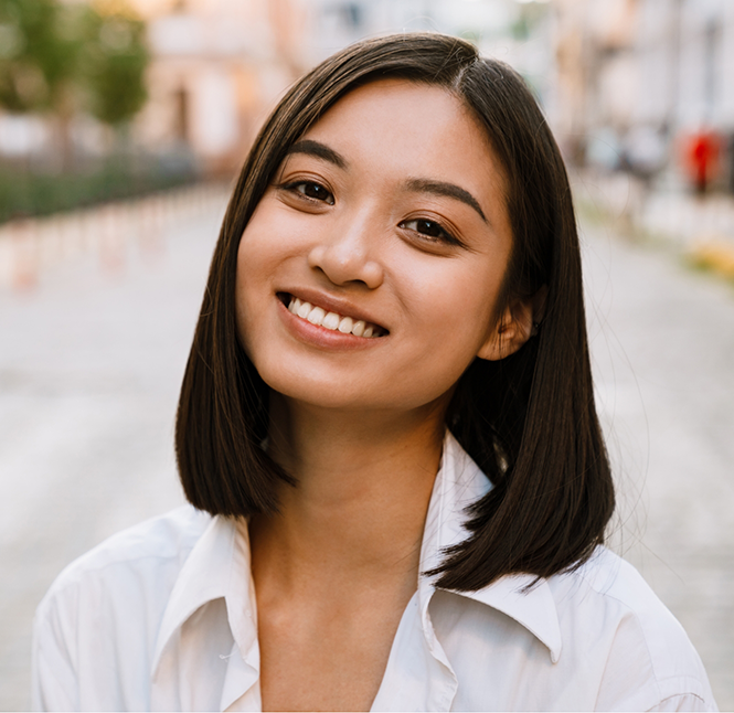Smiling brunette woman in a white collared blouse
