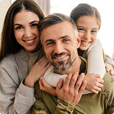 Smiling family of three