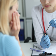 Dentist showing a dental crown to a patient