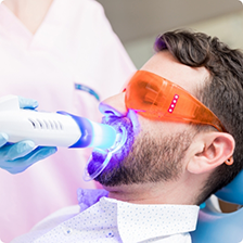 Dental patient getting his teeth whitened