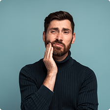 Man holding his cheek in pain