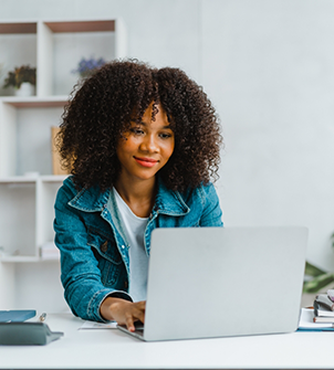 Woman using a laptop at a table