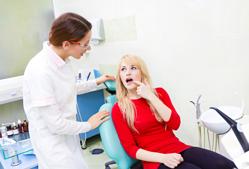 Patient talking to dentist about getting dental fillings repaired