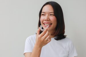 Woman putting in her Invisalign trays